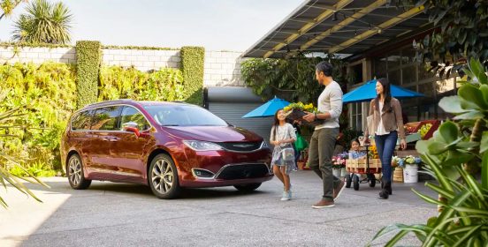 Image of a family getting inside a red Chrysler Pacifica.