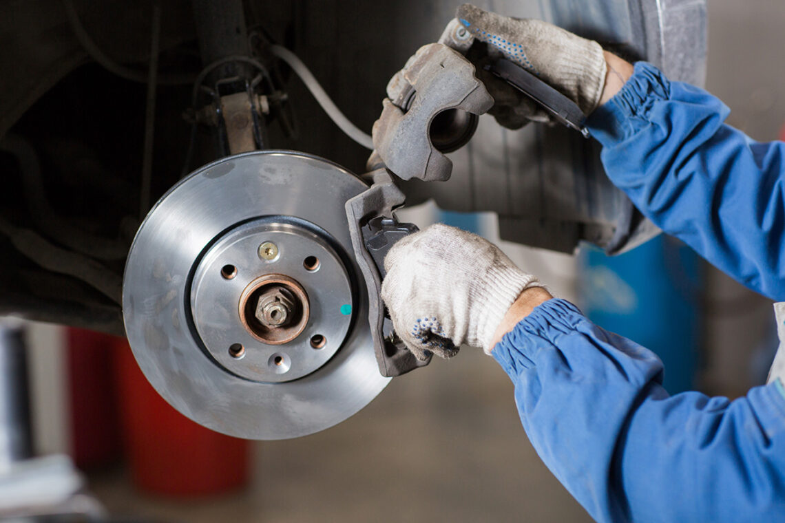 Jeep service technician working on a brake system