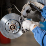 Jeep service technician working on a brake system