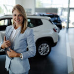 Sales rep greeting customer at auto dealership