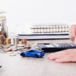 Person calculating used vehicle financing