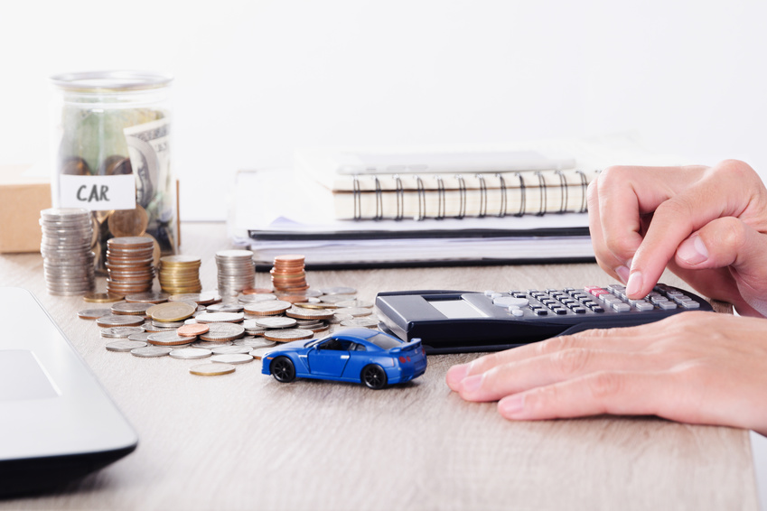 Person calculating used vehicle financing